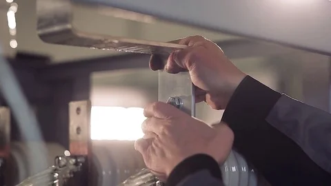 Close-up of hands of factory worker working with metal piece. 스톡 동영상 77006191