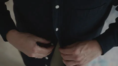 Close-up of hands fastening shirt button before office work Stock Footage 317989645