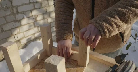 Close-up of the hands of a father and son working together to build a wooden Video stock 328028095