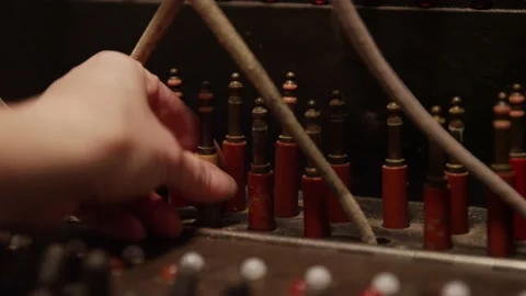 Close up of hands flipping switch and grabbing telephone switchboard cable Stock Footage 131339310