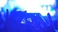 Close-up of hands focusing mobile phone camera on stage, filming concert video HD Footage
