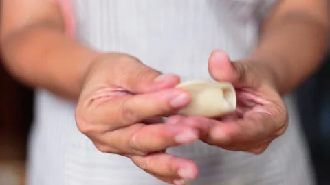 Close up hands folding and crimping with fillings making curry puff. Stock Footage 135888053