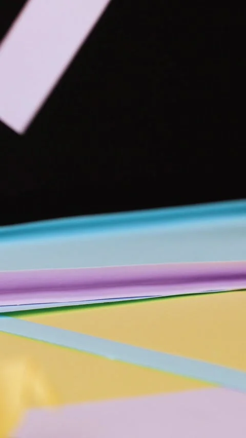 Close Up of Hands Folding Colorful Origami Paper on a Table Stock Footage 327120965