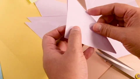 Close Up Hands Folding Pink Origami Paper on Craft Table Stock Footage 327272555