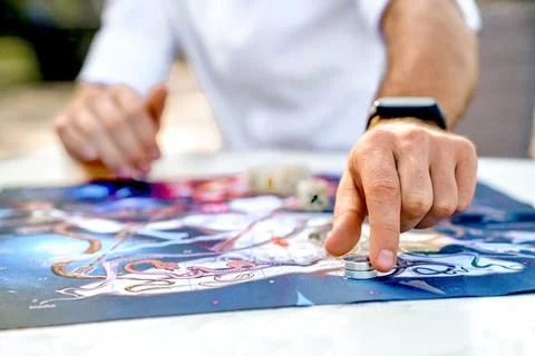 Close-Up of Hands with Game Chip in Form of Ring, Man Makes Move After Rolling Stock Photos