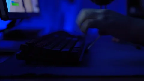 Close-up on the Hands of the Gamer Playing in the Video Game on a Keyboard and Stock Footage 124150557