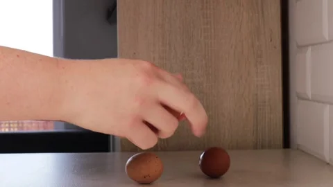 Close-up of hands gently peeling the shell off boiled eggs on a clean surfa.. Stock Footage 320953495
