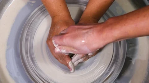 Close-up of hands of a girl apprentice working on a potter's wheel Stock Footage 221170413