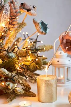 Close-up of the hands of a girl lighting a candle against the backdrop of a Stock Photos