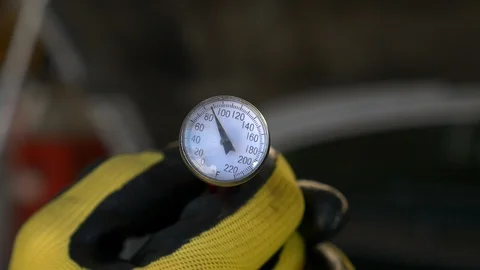 Close-up of hands with gloves holding temperature gauge reading 85 degrees. Stock Footage 100524287