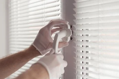 Close-up of hands in gloves with screwdriver, installing a new handle Stock Photos