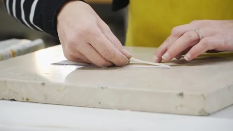 Close-Up of Hands Gluing Leather and Paper Together Stock Footage 279152822