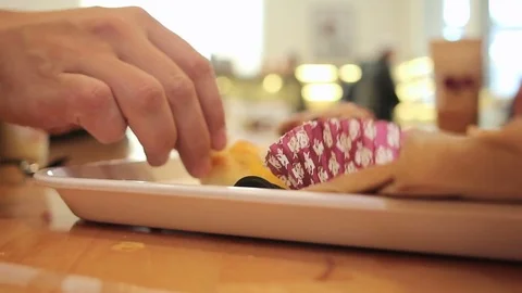 Close up of hands grabbing pastry Видео 83663667