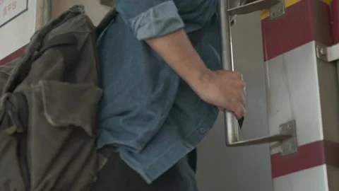 Close up hands grabbing the train railing for safety and stepping on the train. 스톡 동영상 220427136