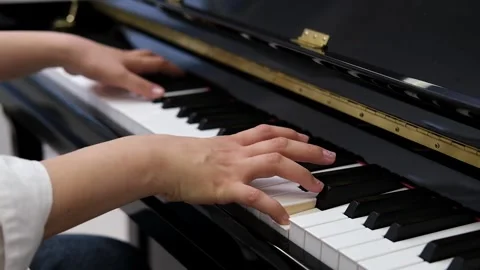 Close-up of hands gracefully playing piano keys. Elegance and serenity of piano Stock Footage 320171733