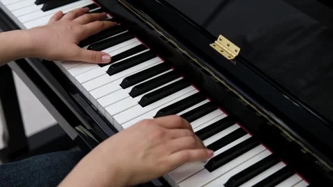 Close-up of hands gracefully playing piano keys. Elegance and serenity of piano Stock Footage 320171746