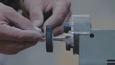 Close-up of hands grinding a metal knife on a grindstone machine. 4k. 4k video Stock Footage 116475002