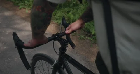 Close-up of hands gripping handlebars while cycling Stock Footage 312354828