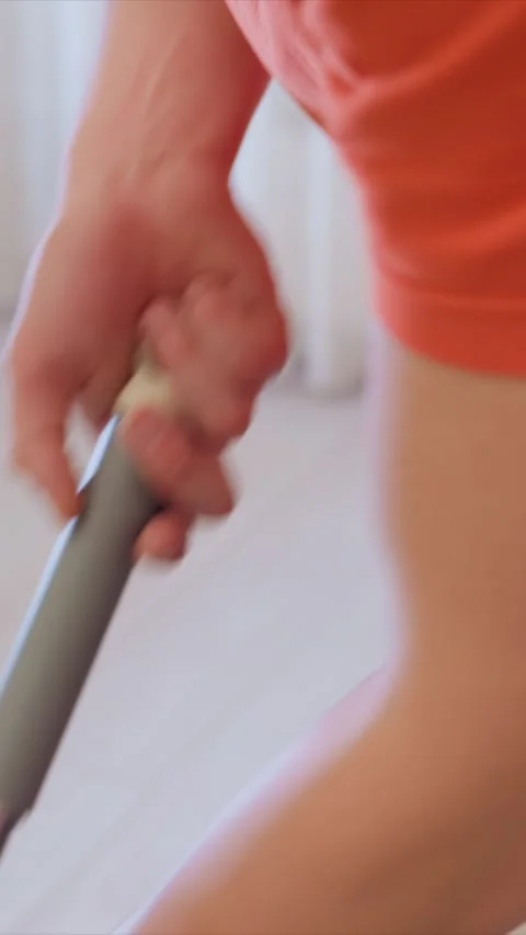 Close up of hands gripping mop handle during floor cleaning showing handheld Stock Footage 346787236