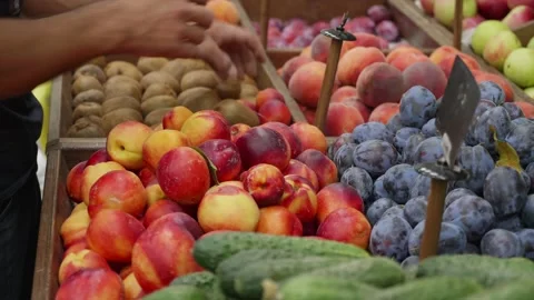 Close-up hands of grocery worker is arranging organic fruits on store shelves. Stock Footage 141647541