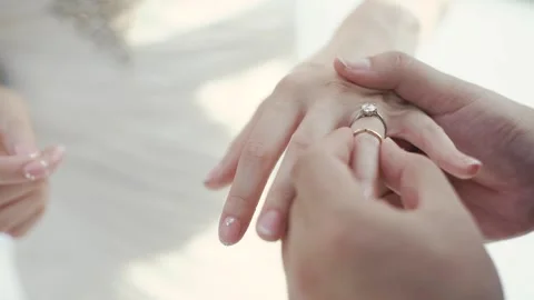 Close Up Hands Of Groom Puts The Wedding Diamond Ring To The Bride. Stock Footage 159331521