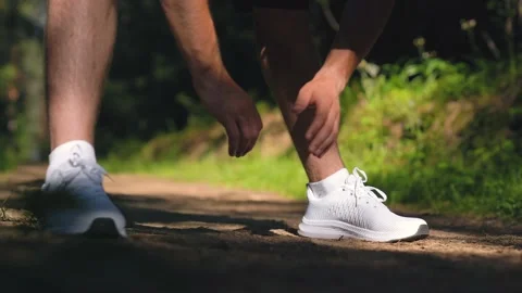 Close-up of hands, the guy bending  over doing exercises. Warm up in park Stock Footage 157071621