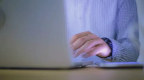 Close-up of hands of the guy which works at office behind the laptop Stock Footage 62550186