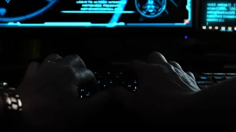 Close up of the hands of a hacker cyber criminal, typing rapidly on a Stock Footage 107589136