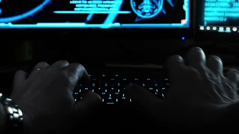 Close up of the hands of a hacker cyber criminal, typing rapidly on a Stock Footage 107589168