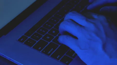 Close-up hands of hacker typing code on laptop keyboard. Stock Footage 197289758