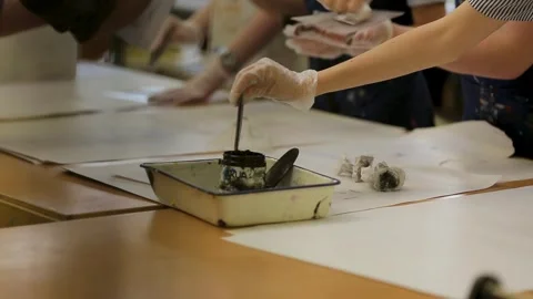 Close up of hands hands ink printing in an art class Stock Footage 296845991