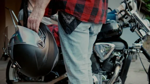 Close up hands with helmet Man going to garage holding a motorcycle helmet while Stock Footage 347986856