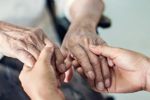 Close up hands of helping hands elderly home care. Mother and daughter. Stock Photos