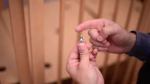 Close-up hands hold bolt and spin it.Сarpenter's tools. Horizontal 4k footage Stock Footage 250072844