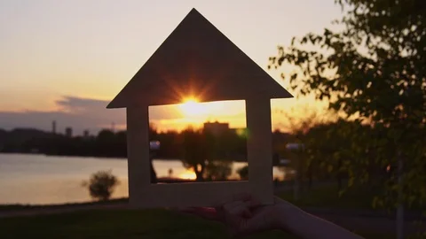 Close-up hands hold the house at sunset. Stock Footage 108309074
