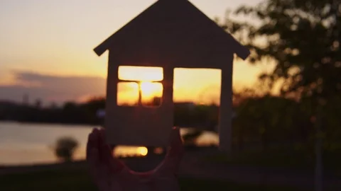 Close-up hands hold the house at sunset. Stock Footage 108930269