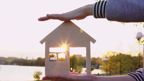 Close-up hands hold the house at sunset. Stock Footage 111015583