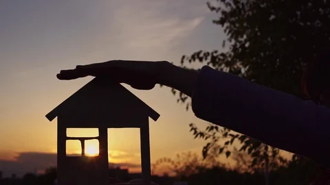 Close-up hands hold the house at sunset. Stock Footage 111015892