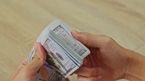 Close up of Hands holding and counting big stack of cash money dollars Stock Footage 338416959