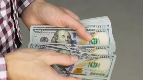 Close up of hands holding and counting several one hundred dollar bills Stock Footage 341038126