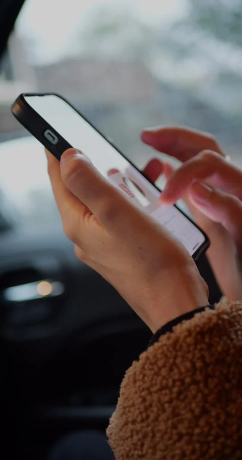 Close-up of hands holding and tapping on a smartphone screen... Stock Footage 319883449