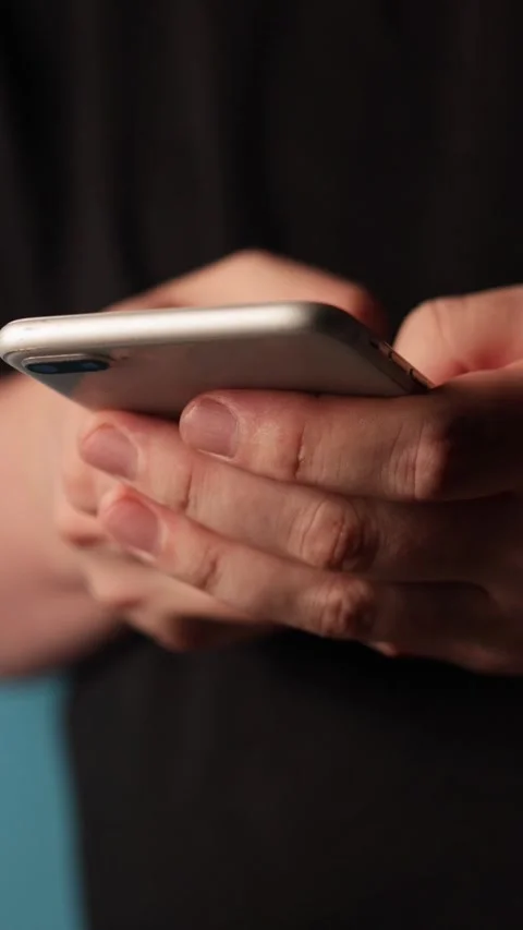 Close-up of hands holding and typing on a smartphone screen Stock-Footage 343838188