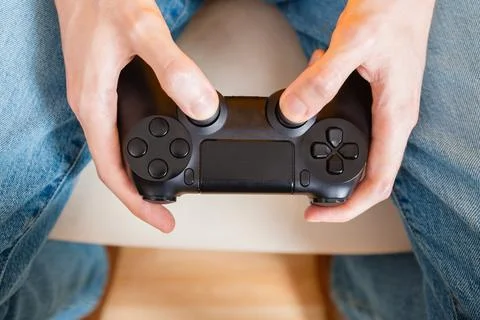 Close-Up of Hands Holding Black Game Controller Stock Photos