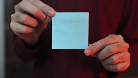 Close Up of Hands Holding Blank White Sticky Note with Copy Space Stock Footage 337847397