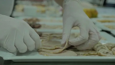 Close up on hands holding a brisket on a white dish, quickly slicing cooked meat Stock Footage 72140844