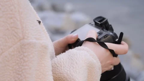 Close-up of hands holding camera near shoreline Stock Footage 341475993