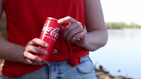 Close-up of hands holding a can of Coca-Cola Original Taste Stock Footage 334792421