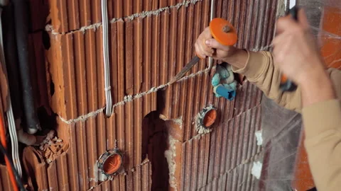 Close up hands holding chisel and hitting hammer. worker expanding grooves Stock Footage 234561562