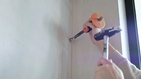 Close up hands holding chisel and hitting hammer. worker expanding grooves. Stock Footage 235812673