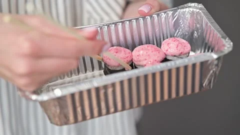 Close-up of hands holding chopsticks to pick up sushi rolls from a silver 스톡 동영상 337556396